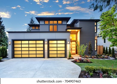 Beautiful Exterior Of Contemporary Home With Two Car Garage Spaces At Sunset. Northwest, USA