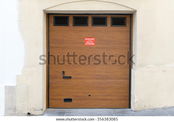 beautiful Exterior Garage Door architecture made from\
wood protecting the cars people store inside in Valletta Malta /\
Garage Doors 10