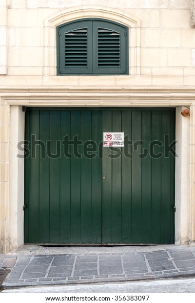 beautiful Exterior Garage Door architecture made from\
wood protecting the cars people store inside in Valletta Malta /\
Garage Doors 7