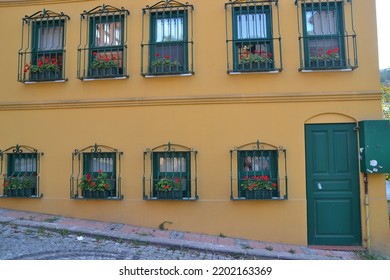 Beautiful Exterior House View With Windows At Kuzguncuk, Painted Yellow House, Istanbul, Turkey, August 2012. No People, Kuzguncuk Street View, Window View With Many Flowers, Geometrical House View.