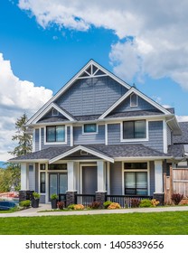 Beautiful Exterior Of Newly Built Luxury Home. Yard With Green Grass And Landscape.