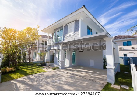 Beautiful exterior of newly home with green grass and blue sky during at sunrise.Front View of New Residential house for sale.Home For Sale,Rent,Housing and Real Estate concept.