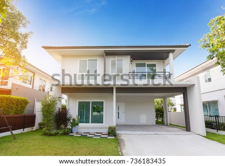 Beautiful exterior of newly home with green grass and blue sky during at sunrise.Front View of New Residential house for sale.Home For Sale,Rent,Housing and Real Estate concept.