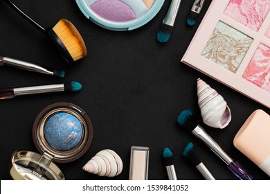 Beautiful Eye Shadow Box, Rainbow Highlighter, Makeup Brushes, Baked Bronzer On A Dark Background