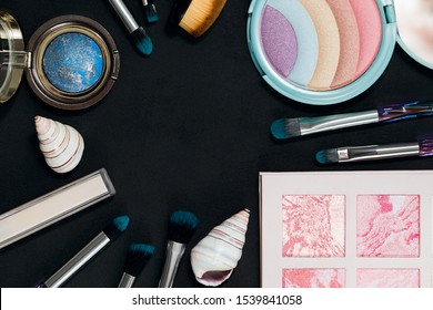 Beautiful Eye Shadow Box, Rainbow Highlighter, Makeup Brushes, Baked Bronzer On A Dark Background