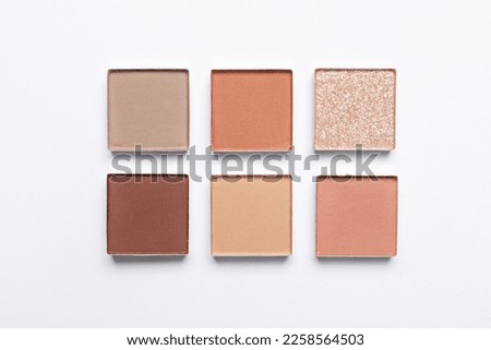Beautiful eye shadow refill pans on white background, flat lay