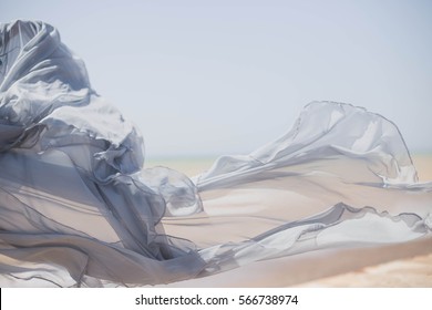 Beautiful Fabric Satin Tulle In The Wind, The Movement On Desert, Sea, Nature, Summer