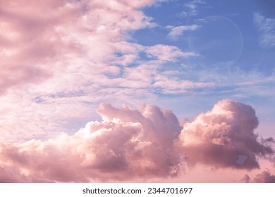 Beautiful fabulous pink cumulus clouds in the blue sky at sunset. natural background