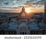 The beautiful facade of the Cec Palace in Calea Victoriei (Victoriei Avenue) in the historic center of Bucharest, Romania, at sunset.