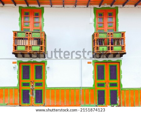 Beautiful facades of the houses Salento city in Colombia. Colorful door of traditional houses, green, orange, purple