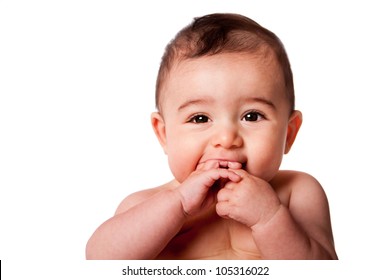 Beautiful Face Of A Happy Cute Baby Infant With Hands In Mouth, Isolated.