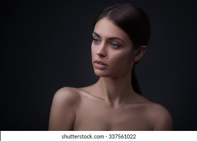 Beautiful Face Of Young Adult Woman With Clean Fresh Skin Isolated On Black Background