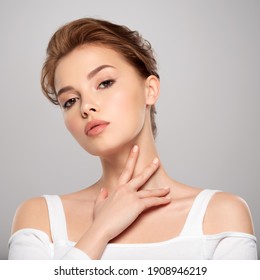 Beautiful face of young caucasian woman with perfect healthy skin, isolated.   Pretty white model caring of face. Beauty treatment concept. Skin care concept.
