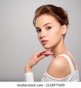 Beautiful face of young caucasian woman with perfect healthy skin, isolated.   Pretty white model caring of face. Beauty treatment concept. Skin care concept.