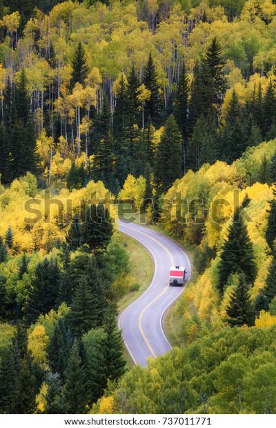 Beautiful fall color curve road in Mable, Colorado.\
RV commuting on a zigzig\
road.