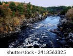 Beautiful fall scene of the St. Croix River  flowing through Interstate Park on a cold October day in Taylors Falls, Minnesota USA.