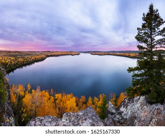 A beautiful fall sunrise from the Honeymoon Bluff overlooking Hungry Jack Lake and peak fall colors in northern Minnesota. 