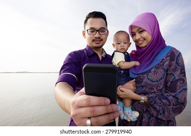 Beautiful Family At Beach Making A Self Portrait With A Mobile Phone