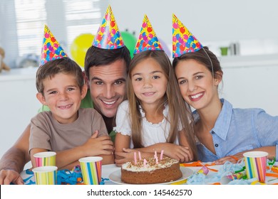 Beautiful Family Celebrating A Party With A Chocolate Birthday Cake