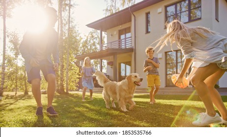 Beautiful Family of Four Play Catch Toy Ball with Happy Golden Retriever Dog on the Backyard Lawn. Idyllic Family Has Fun with Loyal Pedigree Dog Outdoors in Summer House Backyard. - Shutterstock ID 1853535766