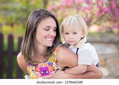 Beautiful Family, Mother, Father And Three Kids, Boys, Having Familly Outdoors Portrait Taken On A Sunny Spring Evening, Beautiful Blooming Garden, Sunset Time, Back Lit. Parents And Children Have Fun