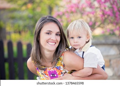 Beautiful Family, Mother, Father And Three Kids, Boys, Having Familly Outdoors Portrait Taken On A Sunny Spring Evening, Beautiful Blooming Garden, Sunset Time, Back Lit. Parents And Children Have Fun