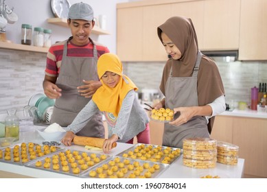 beautiful family of muslim making nastar pineapple cake of indonesian tradition together at home