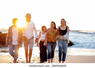 A Beautiful Family On A Beach. Golden Light With Rocks. A Loving Family With Teenager Children. 