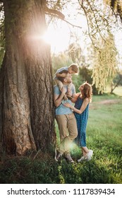 Beautiful Family On Nature Countryside Father Mother Son Sunset