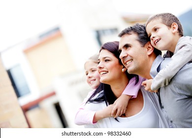 Beautiful Family Outside Their House Looking Away