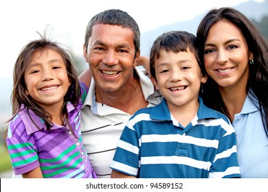 Beautiful family portrait looking happy and smiling outdoors