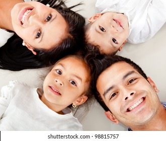 Beautiful Family Portrait Lying On The Floor With Heads Together