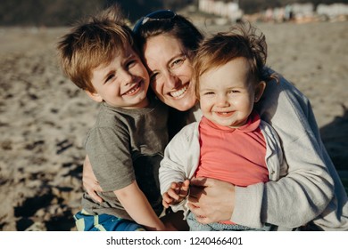 Beautiful family portrait showing a mother with her son and daughter - Shutterstock ID 1240466401