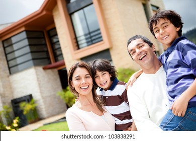 Beautiful family portrait smiling outside their new house