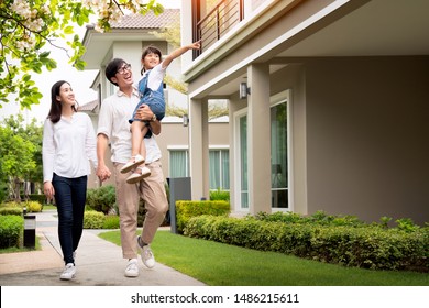 Beautiful family portrait smiling outside their new house with sunset, this photo canuse for family, fathe, mother and home concept