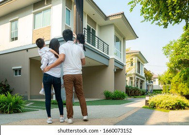 Beautiful Family Portrait Smiling Outside Their New House With Sunset, This Photo Canuse For Family, Father, Mother And Home Concept