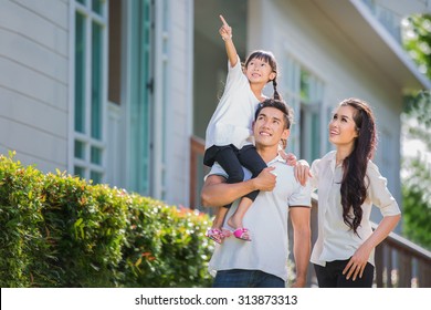 Beautiful Family Portrait Smiling Outside Their New House