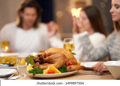 Beautiful Family Praying Over Festive Dinner At Home