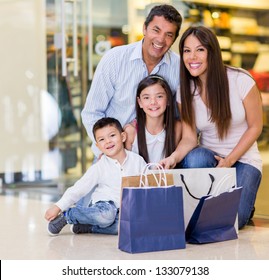 Beautiful Family Shopping At The Mall And Looking Very Happy