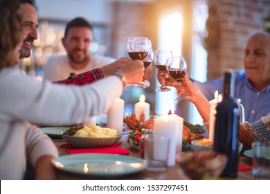 Beautiful Family Smiling Happy And Confident. Eating Roasted Turkey And Toasting With Cup Of Wine Celebrating Thanksgiving Day At Home