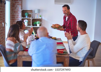 Beautiful family smiling happy and confident. Showing roasted turkey and applauding celebrating Thanksgiving Day at home - Shutterstock ID 1537297493