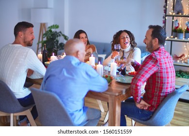 Beautiful family smiling happy and confident. Eating roasted turkey celebrating Christmas at home - Shutterstock ID 1560151559