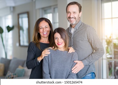 Beautiful family together. Mother, father and daughter smiling and hugging with love at home. స్టాక్ ఫోటో