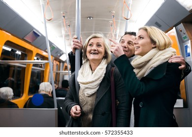 Beautiful Family In Winter Clothes Traveling By Subway Train