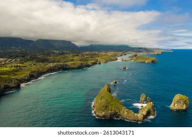 Beautiful and famous Green Coast of Spain. Aerial perspective of Asturian landscape with high cliffs, turquoise water, small islands. Peaceful landscape. Famous travel destination in North of Spain.