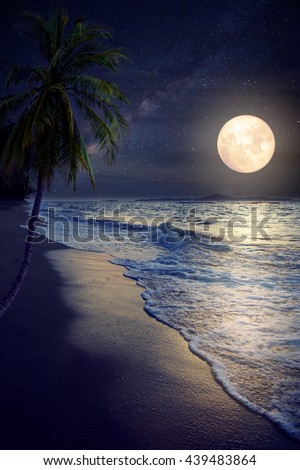 Beautiful fantasy tropical beach with Milky Way star in night skies, full moon - Retro style artwork with vintage color tone (Elements of this moon image furnished by NASA)