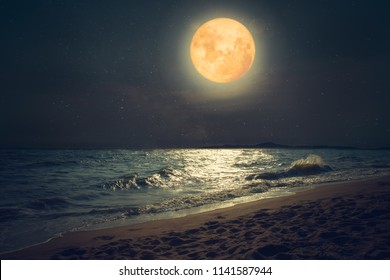 Beautiful fantasy tropical sea beach. Full moon (super moon) with star over seascape in night skies. Serenity nature background at nighttime. vintage and retro color filter style.
