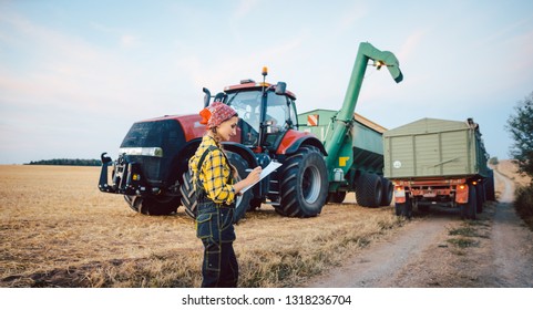 Beautiful Farmer Crunching Numbers Of Field After A Long Harvest Day