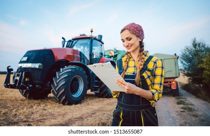 Beautiful Farmer Crunching Numbers Of Field After A Long Harvest Day