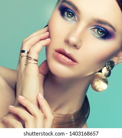 beautiful fashion model wearing elegant jewelry in color light